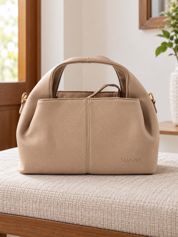 Nuvaara women's warm taupe pebbled vegan leather slouchy curved dome satchel handbag with center vertical seam, dual arched handles, and debossed logo