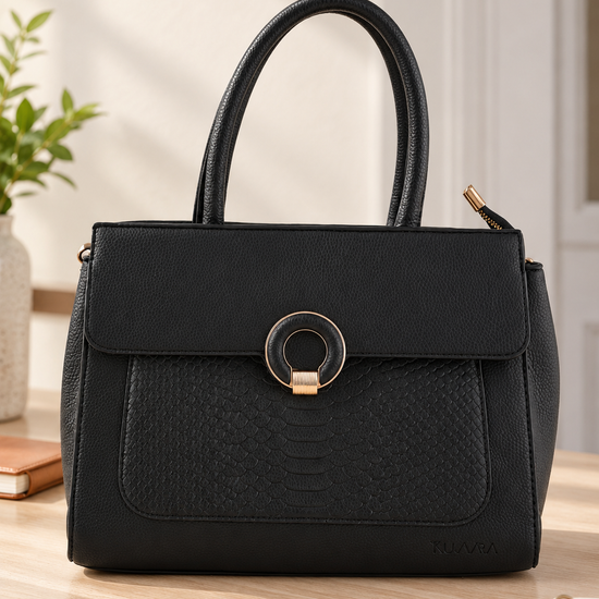 Nuvaara women's midnight black structured satchel handbag featuring an embossed snakeskin front panel, gold ring buckle clasp, and tall rolled top handles