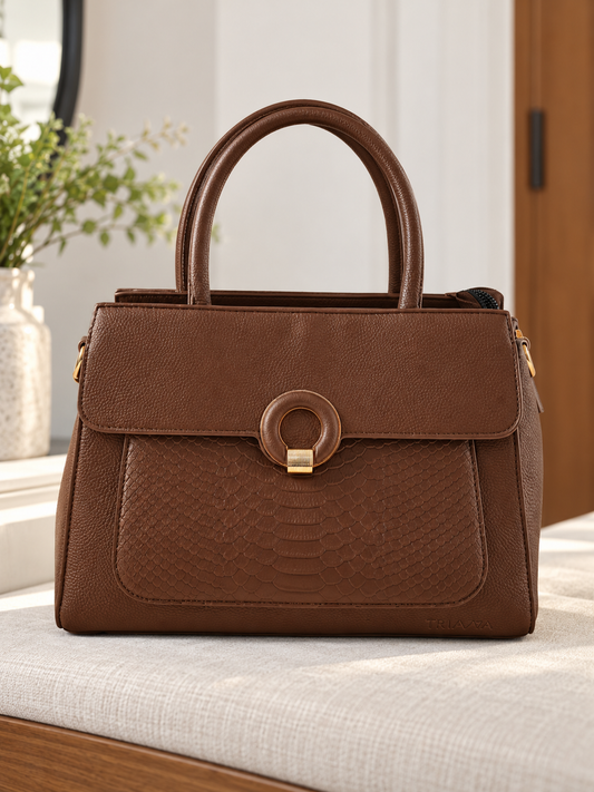 Nuvaara women's cognac brown structured satchel handbag featuring an embossed snakeskin front panel, gold ring buckle clasp, and tall rolled top handles