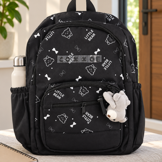 Thilakma Little Bear printed classic black nylon school backpack with white teddy bear motifs, front organizer pocket, and hanging plush bear charm keychain