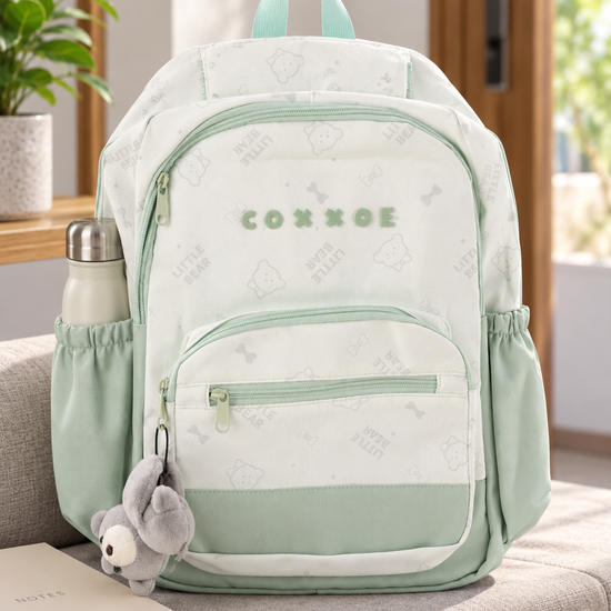 Thilakma Little Bear printed pastel mint green nylon school backpack with white teddy bear motifs, front organizer pocket, and hanging plush bear charm keychain