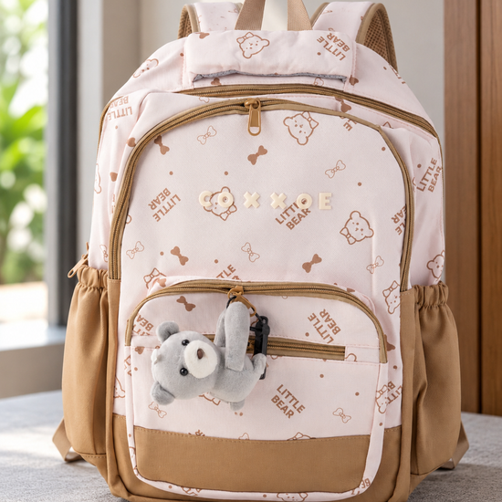 Thilakma Little Bear printed blush pink nylon school backpack with white teddy bear motifs, front organizer pocket, and hanging plush bear charm keychain