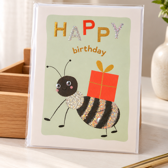 Cute whimsical party bug birthday greeting card with googly eyes and red gift box
