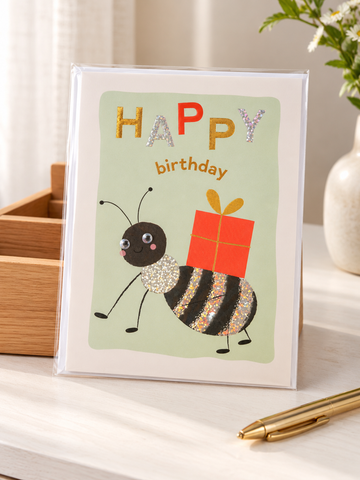 Cute whimsical party bug birthday greeting card with googly eyes and red gift box