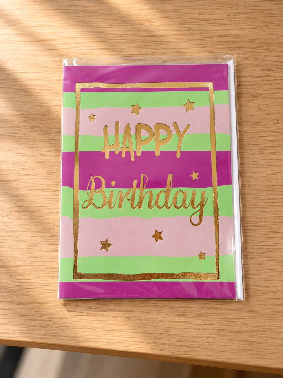 Modern striped birthday greeting card in violet, pink, and mint green with gleaming gold foil frame