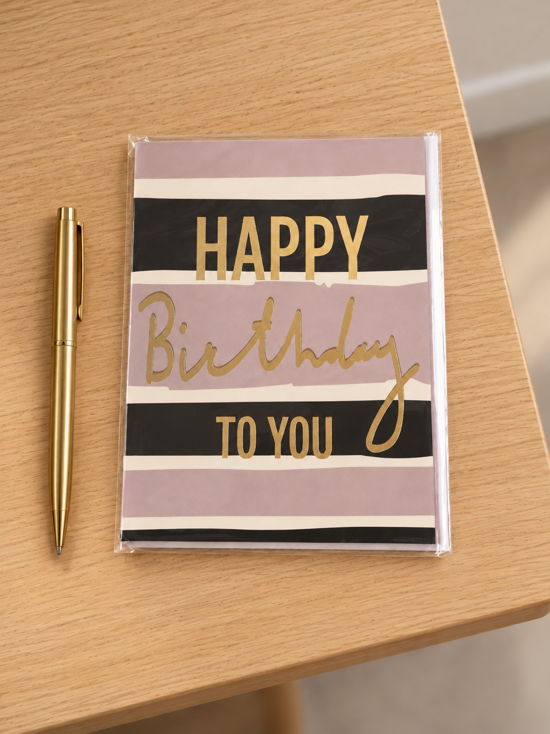 Modern mauve, black, and peach striped Happy Birthday greeting card with shimmering gold foil lettering and matching envelope