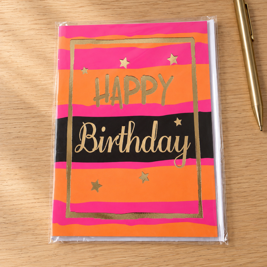 Vibrant sunset pink and orange striped Happy Birthday greeting card with shining gold foil border and lettering