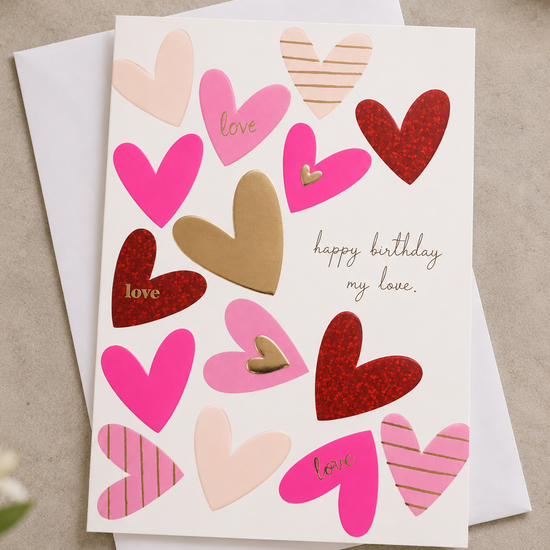Romantic white greeting card with pink, gold foil, and red glitter hearts reading happy birthday my love