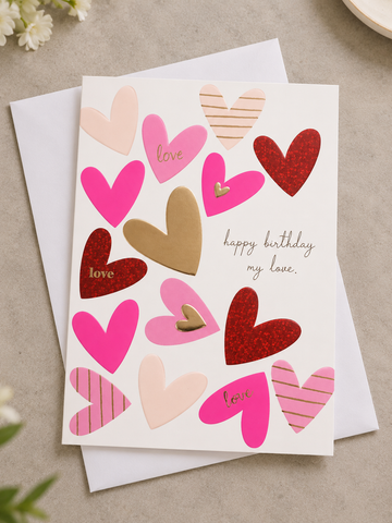 Romantic white greeting card with pink, gold foil, and red glitter hearts reading happy birthday my love