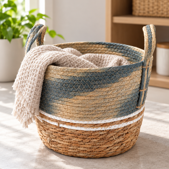 Small blue and beige two-tone handwoven seagrass storage basket with braided handles