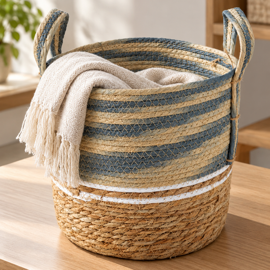 Medium blue and beige two-tone handwoven seagrass storage basket with braided handles