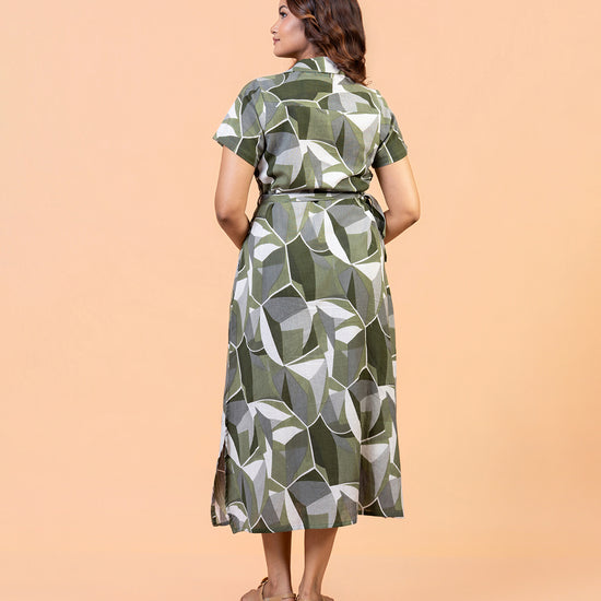 Full shot of model wearing Cinnamon Isle olive green geometric belted shirt dress