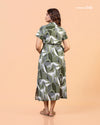 Full shot of model wearing Cinnamon Isle olive green geometric belted shirt dress