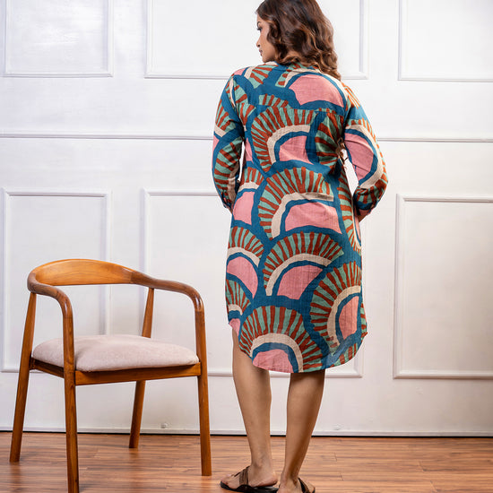 Side view of Cinnamon Isle teal blue mosaic pattern tunic dress