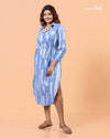 Full shot of model posing in Cinnamon Isle blue linear domino print midi shirt dress