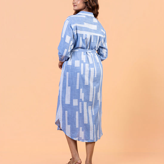 Side view of Cinnamon Isle blue domino patterned collared shirt dress showing tie belt
