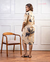 Cinnamon Isle Women's Warm Beige Botanical Leaf Print Shirt Dress back view showing shoulder yoke and curved hem
