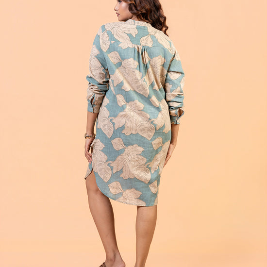Cinnamon Isle Women's Slate Blue Leaf Print Curved Hem Tunic Dress back view showing yoke pleat and curved hem