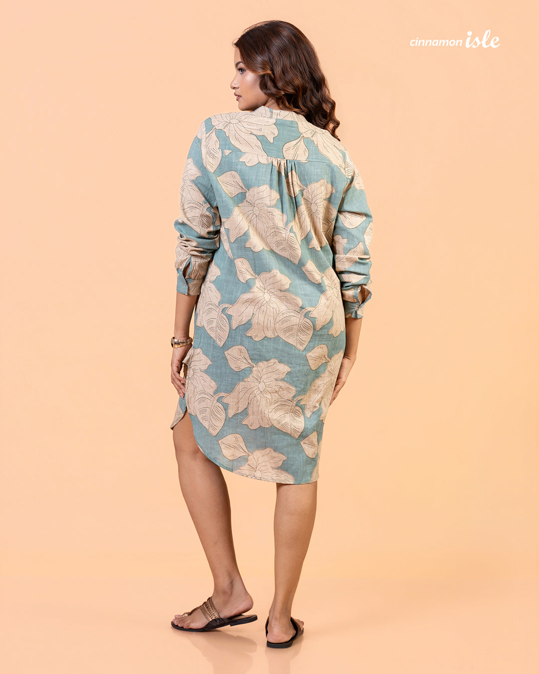 Cinnamon Isle Women's Slate Blue Leaf Print Curved Hem Tunic Dress back view showing yoke pleat and curved hem