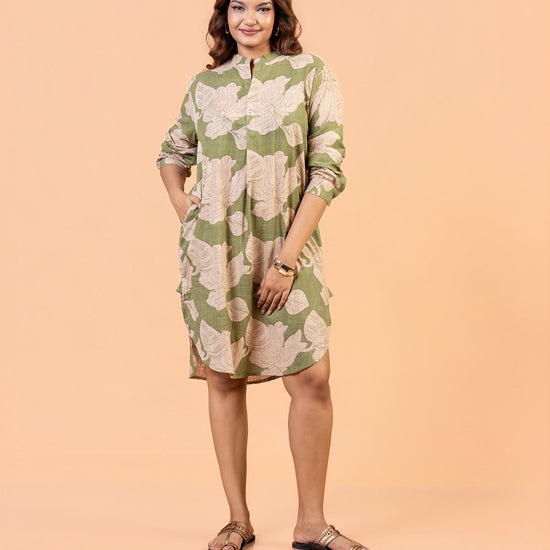 Cinnamon Isle Women's Olive Green Leaf Print Curved Hem Tunic Dress front view with hands in pockets