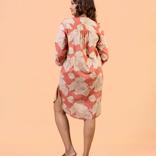 Cinnamon Isle Women's Coral Pink Leaf Print Curved Hem Tunic Dress back view showing shoulder yoke and high-low hem