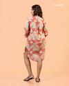 Cinnamon Isle Women's Coral Pink Leaf Print Curved Hem Tunic Dress back view showing shoulder yoke and high-low hem