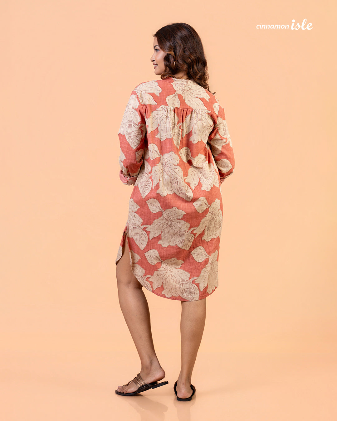 Cinnamon Isle Women's Coral Pink Leaf Print Curved Hem Tunic Dress back view showing shoulder yoke and high-low hem