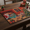 Decorative Christmas placemat with Santa Claus on a wooden table.